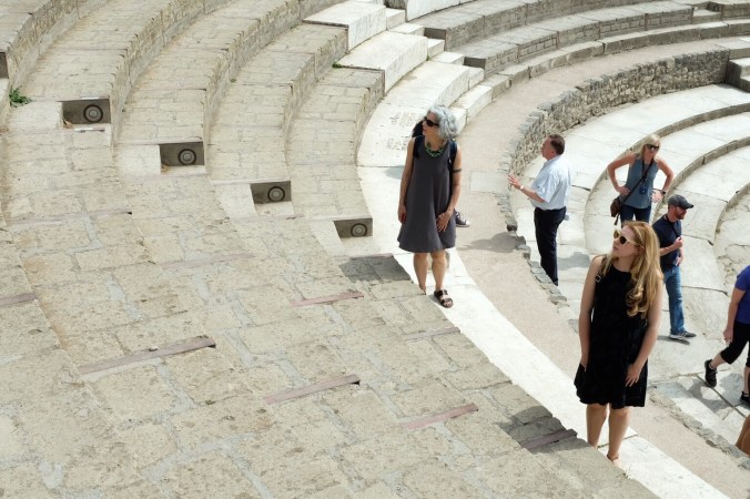 Standing on stairs in an amphitheater in Pompeii