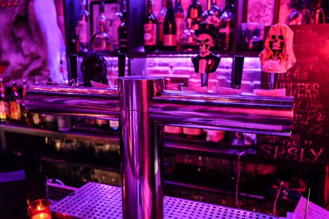 Beetle House beer tap with models of skeletons on top