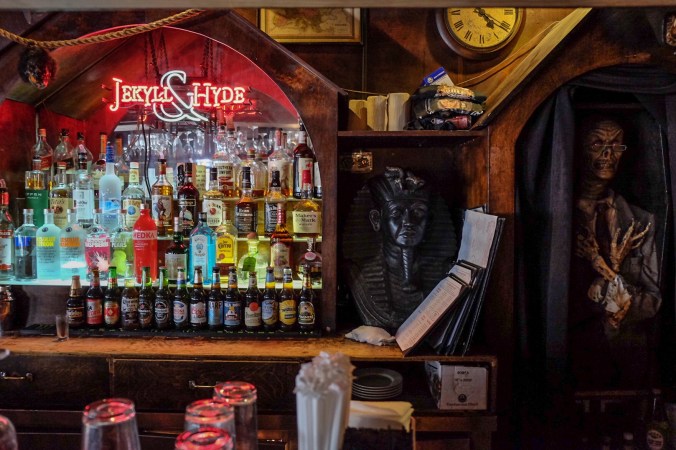 Behind the bar, the sign and more decorations near the booze