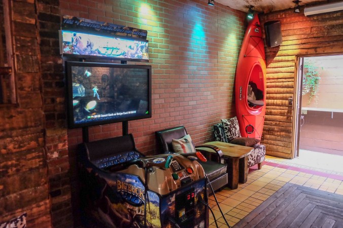 Camp with the buck hunter game in the front and a kayak in back